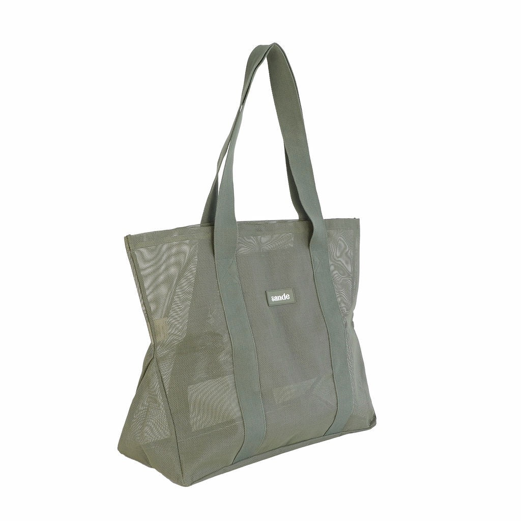 Side view of Sande Beach Hauler Mini mesh beach bag in Pandanus green, shown on a white background, highlighting its large design and durable mesh material.