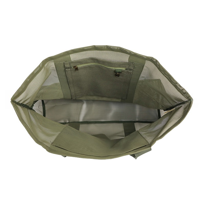 Internal pockets of the Sande Kids Beach Hauler mesh beach bag in olive sage green. White background.
