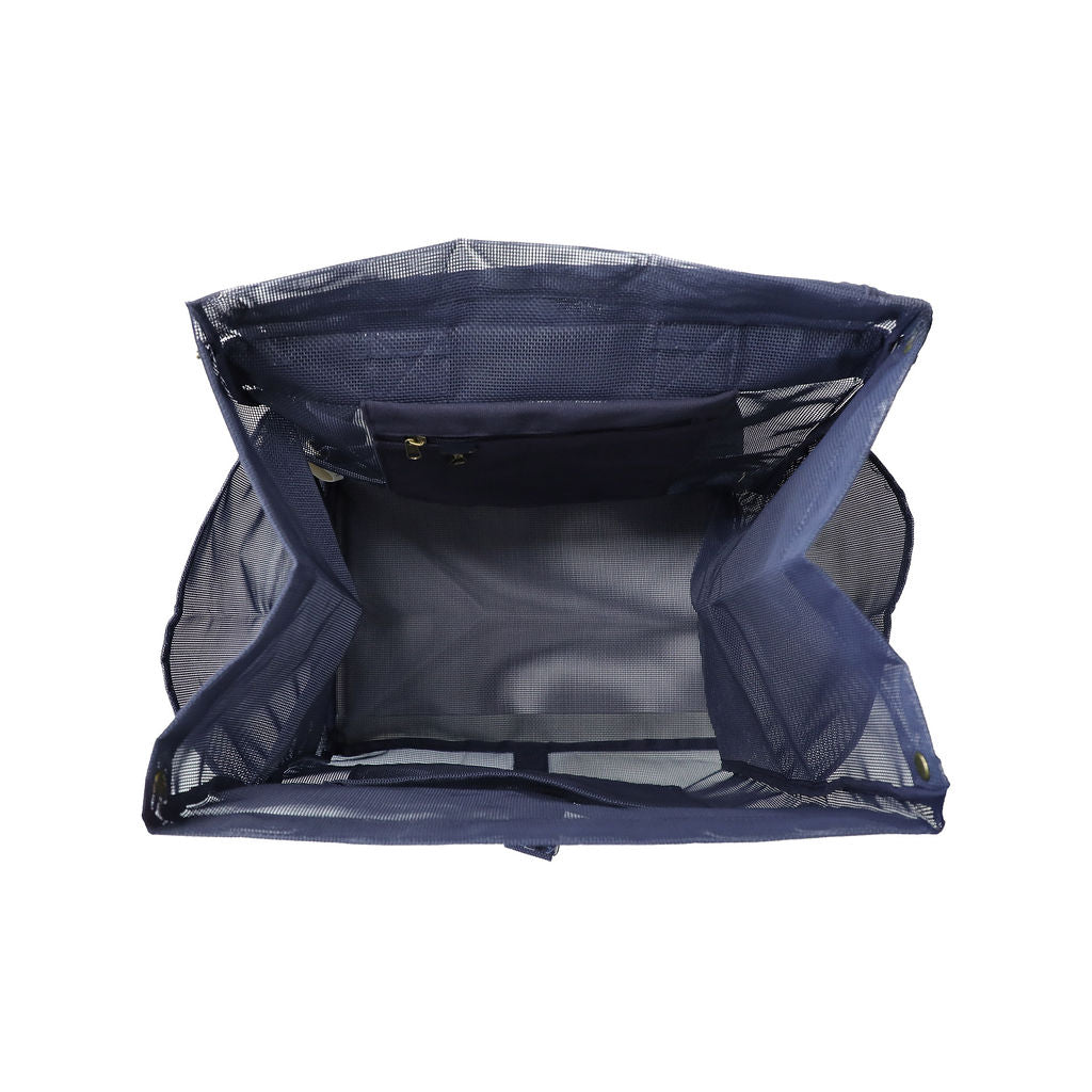 This studio image shows the Sande Beach Hauler mesh backpack in Deep Sea Navy from the top view. It highlights the thick canvas pocket for valuables and a key clip for added security, along with a large mesh pocket to help keep everything organised and easily accessible.