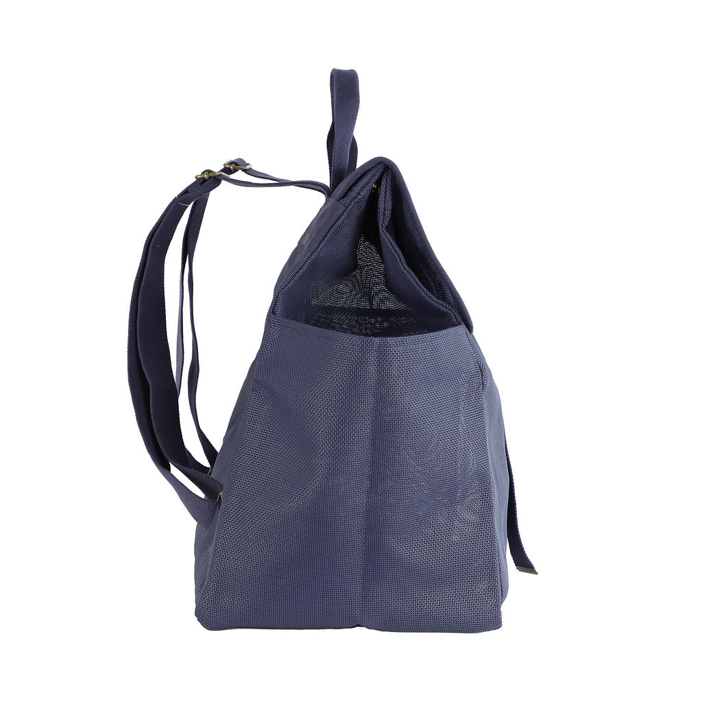 This studio image shows the Sande Beach Hauler mesh backpack in Deep Sea Navy from the side view. The image highlights the adjustable straps for a comfortable fit, a side mesh pocket for easy storage, and the sleek design of the bag, making it both practical and stylish.