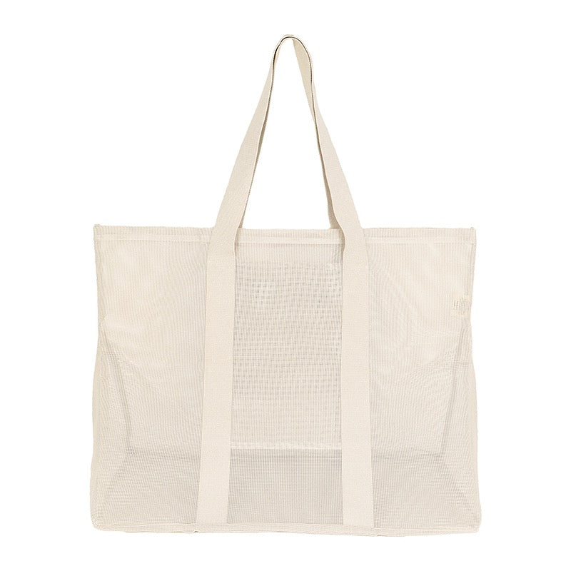 Rear view of the Sande Kids original oversized mesh beach bag in neutral, highlighting its large capacity and durable mesh construction.