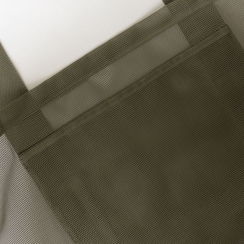 Flat lay of Sande Beach Hauler mesh beach bag, highlighting spacious internal mesh pocket for organised beach essentials.