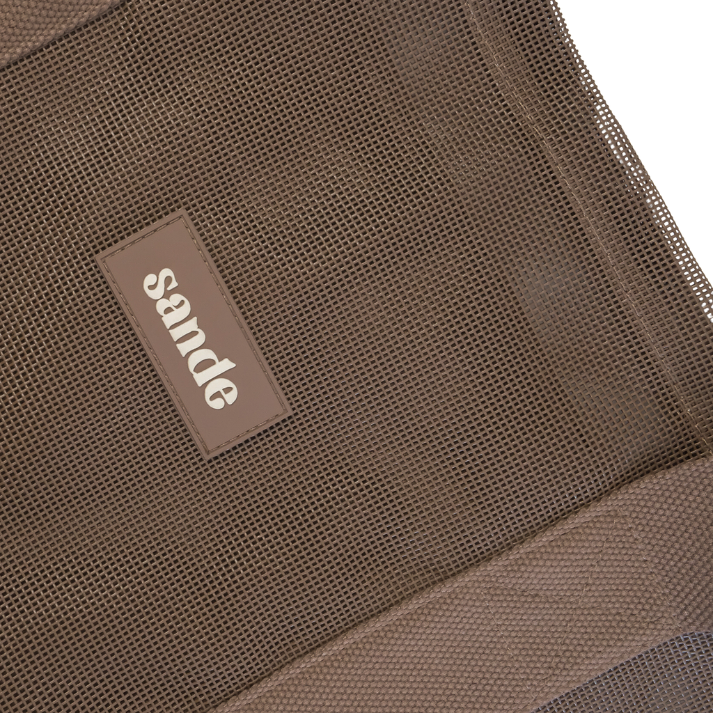 Close-up image of the Sande™ Beach Hauler oversized mesh bag in Espresso Brown, highlighting the durable mesh fabric, thick cotton straps, and silicone Sande logo. Perfect for carrying beach essentials on family beach days, market trips, and outdoor adventures.
