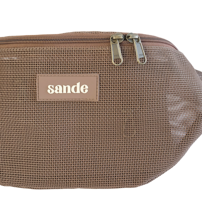 Close up studio detail of the Sande Essentials Crossbody Bag in Espresso, highlighting the espresso mesh fabric, silicone Sande logo and dual YKK brass zipper pulls on the espresso brown zip.