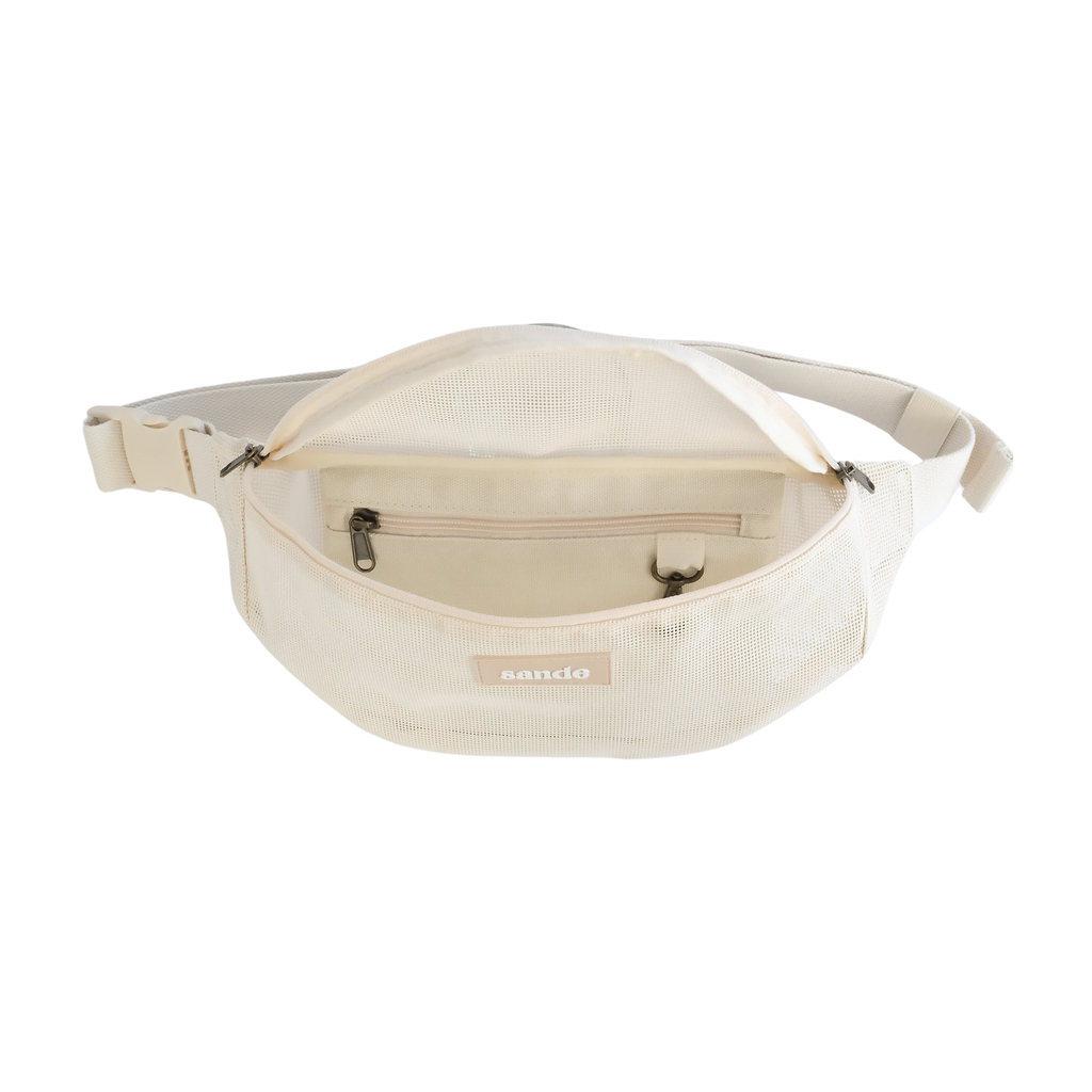 Front view of the Sande Essentials Crossbody Bag in Sand on a white background, shown open to reveal the internal secure canvas pocket and key clip. The internal arrangement is uniquely designed by Sande.