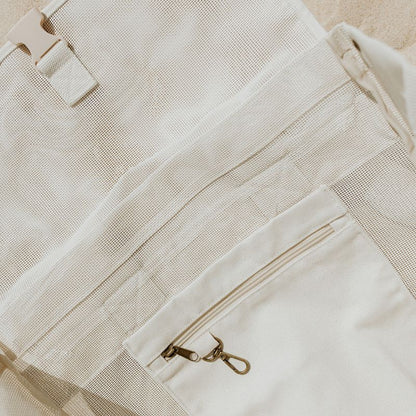 Close-up of the internal secure canvas pocket and key clip in the Sande  Beach Hauler mesh backpack, designed to keep valuables safe.