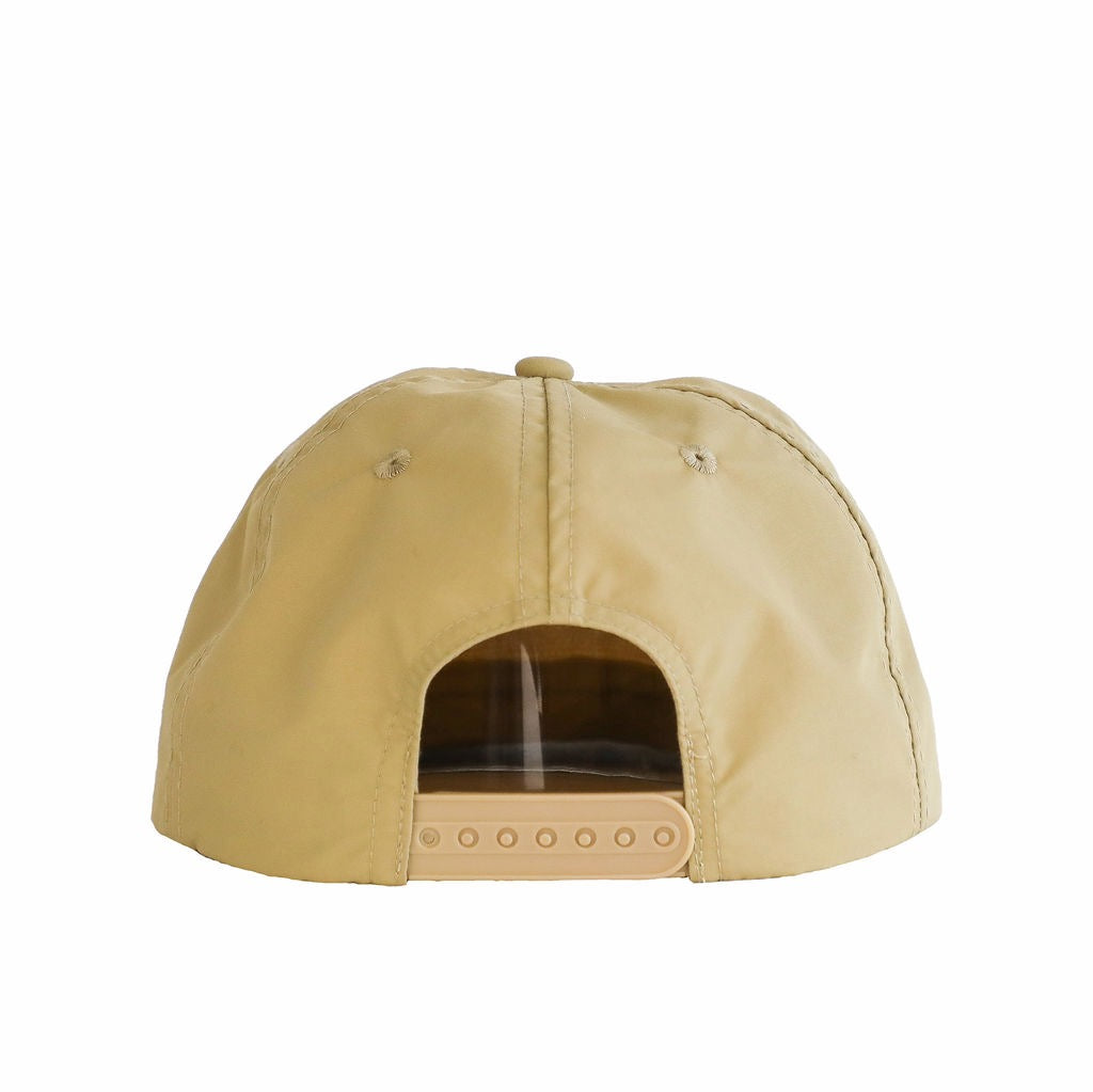 A beige cap made from waterproof nylon fabric, shown from the rear. The cap features a plastic snapback and the Sande logo embroidered in white on the front.
