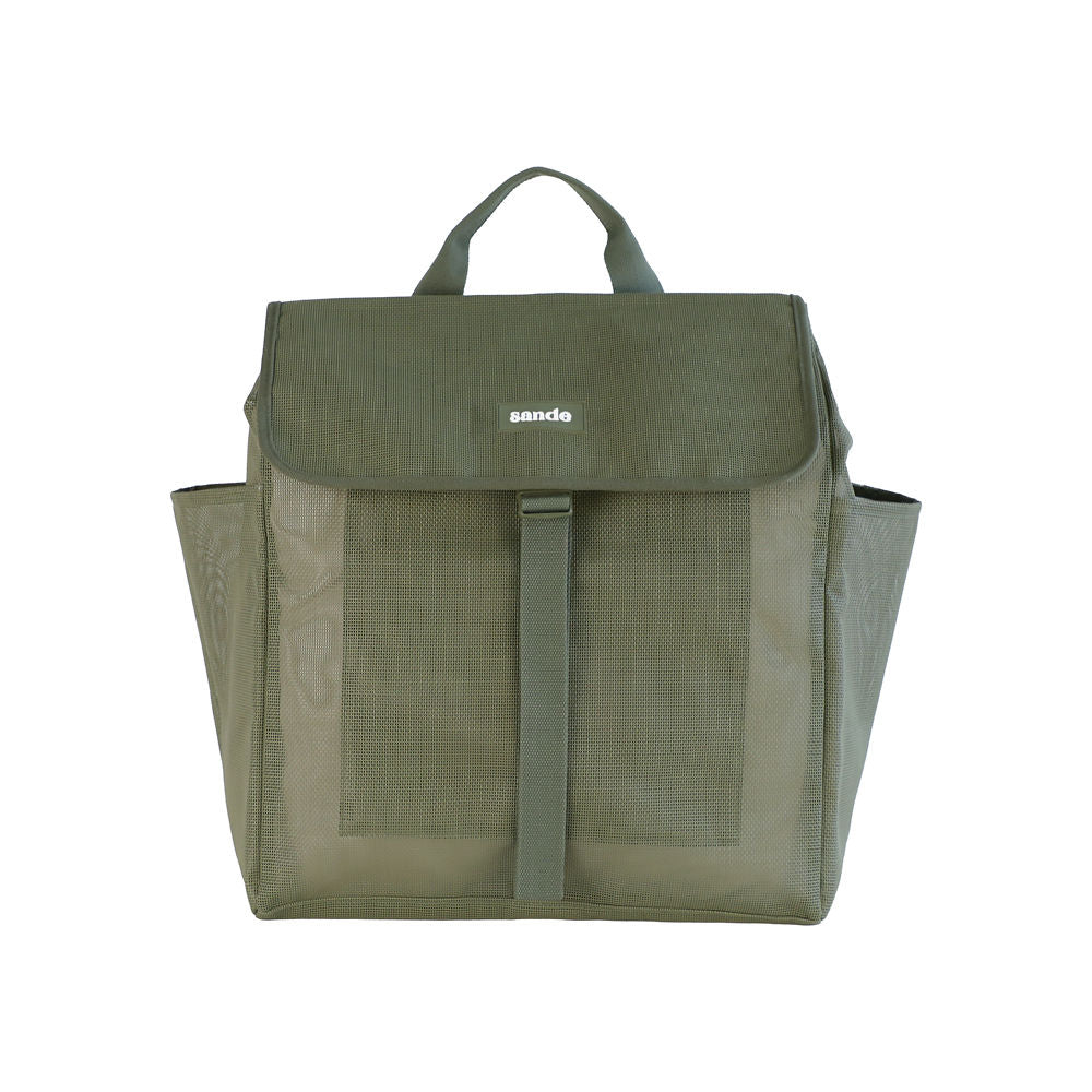A studio image of the Sande Beach Hauler mesh backpack in Pandanus Green, shown from the front to highlight its details. The backpack features a flap with a plastic clip, adjustable strap, large side mesh pockets, and a handle at the top. Set against a white background.