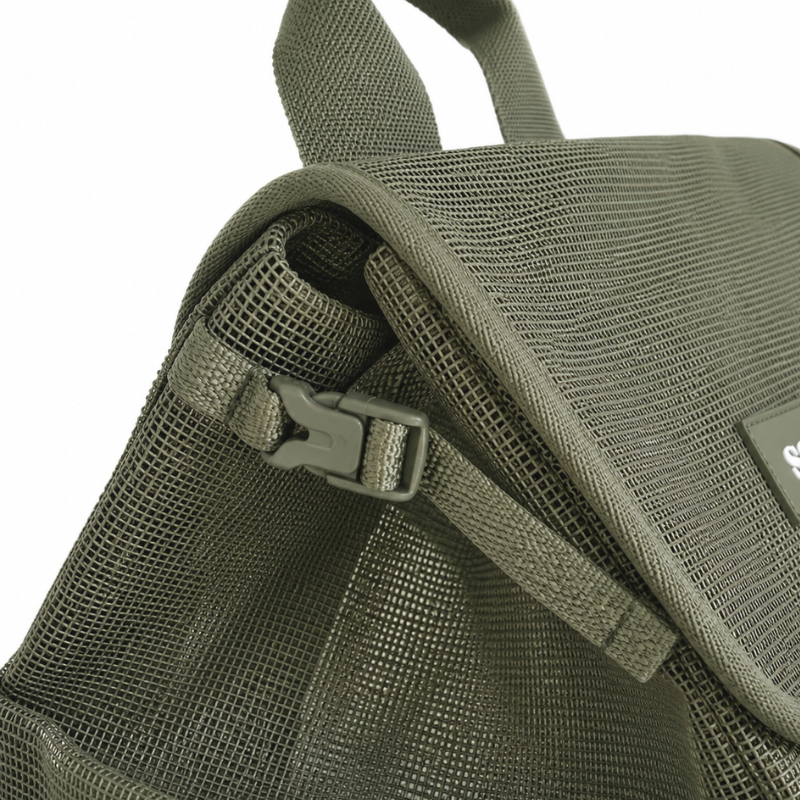 Small side clips shown on the sides of the Sande Beach Hauler mesh backpack in olive green. Used to compress the backpack when carrying lighter loads.