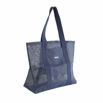 Sande Beach Hauler - large mesh beach bag in Deep Sea Navy, displayed in a studio setting at a 45¬∞ angle. This view highlights the mesh detail, thick cotton straps, durable construction, and the silicone label with the Sande logo. Set against a white background.