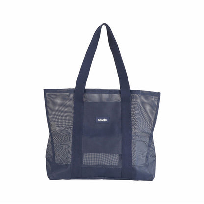 Sande Beach Hauler - large mesh beach bag in Deep Sea Navy, displayed in a studio setting. Shown front-on to highlight the mesh detail, thick cotton straps, and durable construction. shows silicon label with Sande logo. Set against a white background.