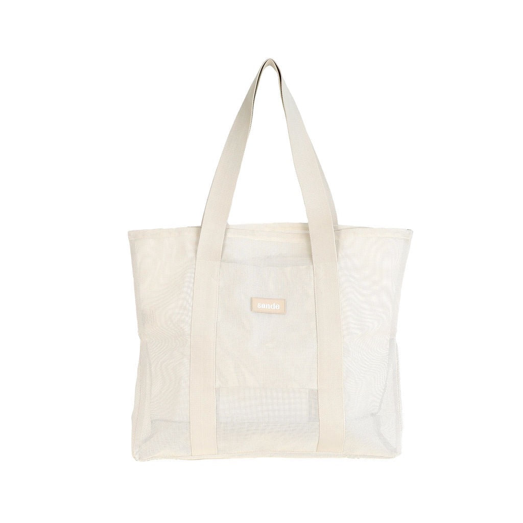 Front view of the Sande Beach Hauler Mini mesh beach bag in Sand/neutral colorway against a white background. This stylish and functional beach bag is designed for families, showcasing its spacious interior and durable mesh fabric, perfect for beach outings and outdoor activities.