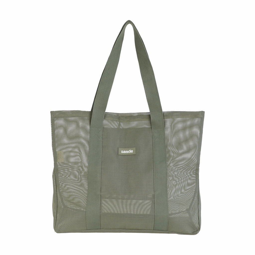Front view of Sande Beach Hauler -Mini mesh beach bag in Pandanus green, shown on a white background, highlighting its large unique design.