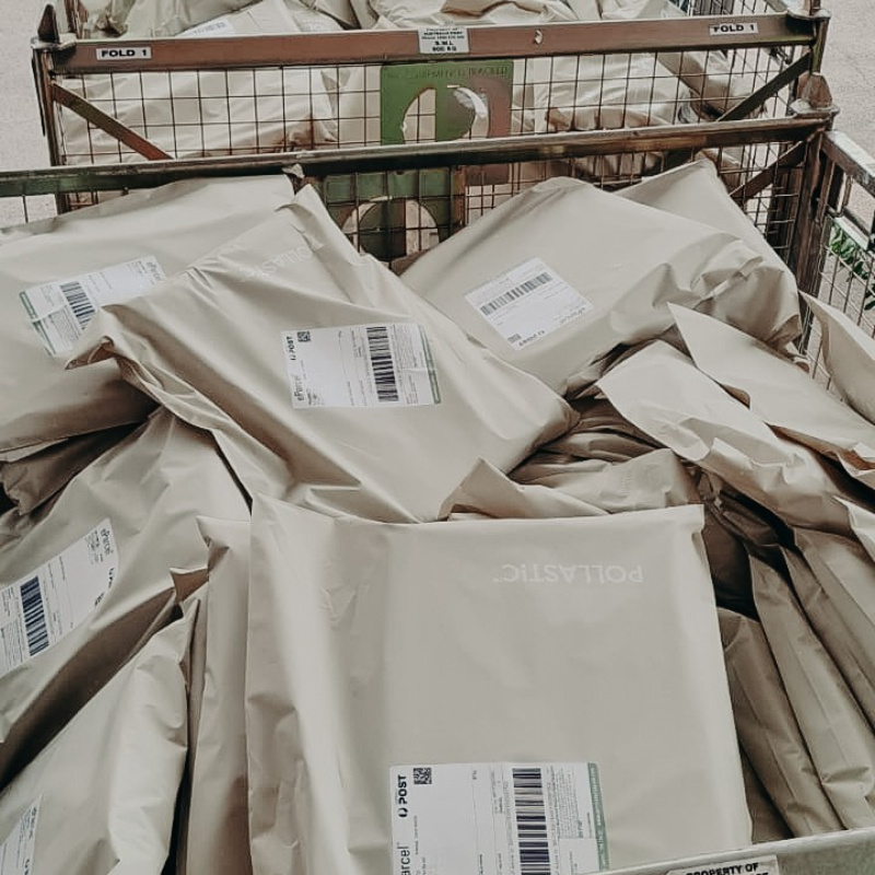 Sande orders ready to be shipped to customers. Each order is in a Better Packaging Co Pollastic Satchel. They are waiting in large wire cages to be collect by the postal service.
